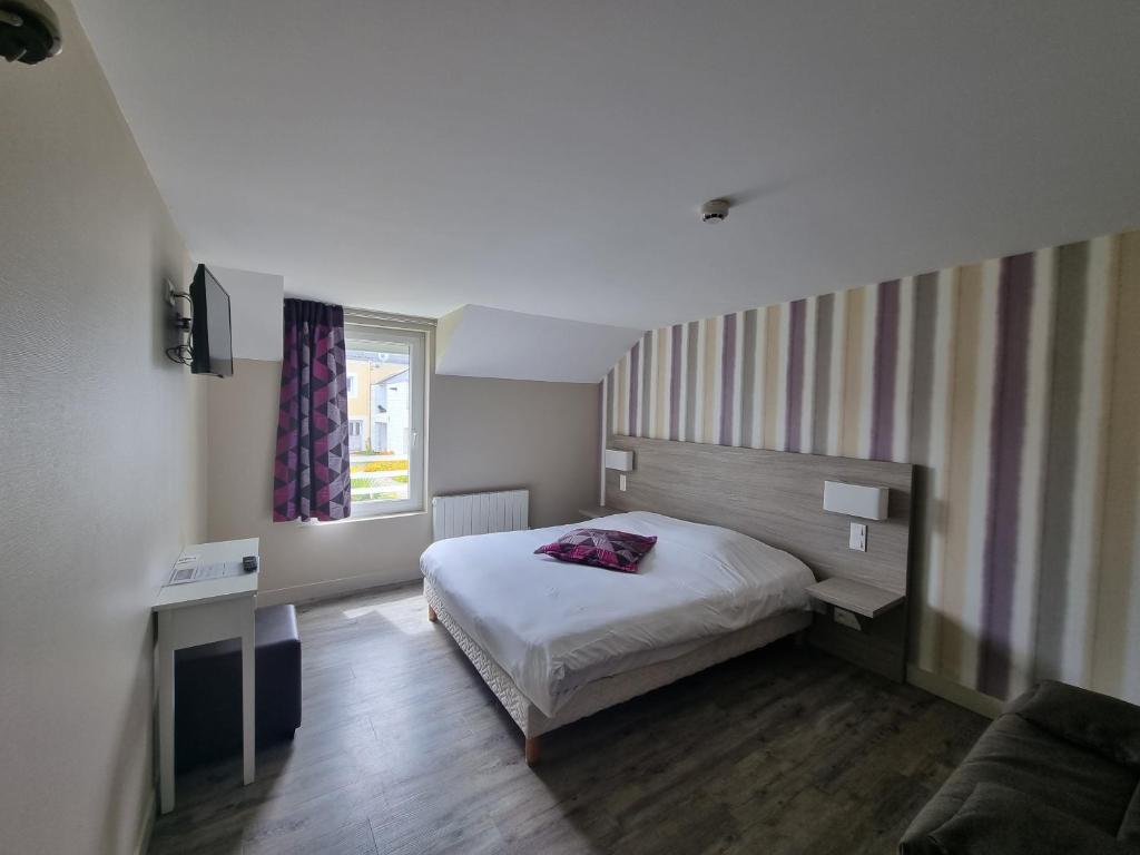 Postel nebo postele na pokoji v ubytování Hôtel Vauban