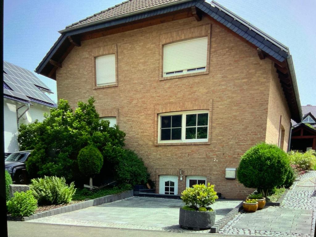 a large brick house with windows and a driveway at Moselweinlaub in Bruttig-Fankel