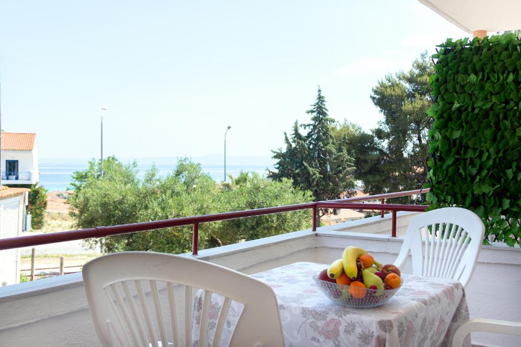 - une table avec un bol de fruits sur le balcon dans l'établissement DIMITRIS STUDIO, à Polychrono