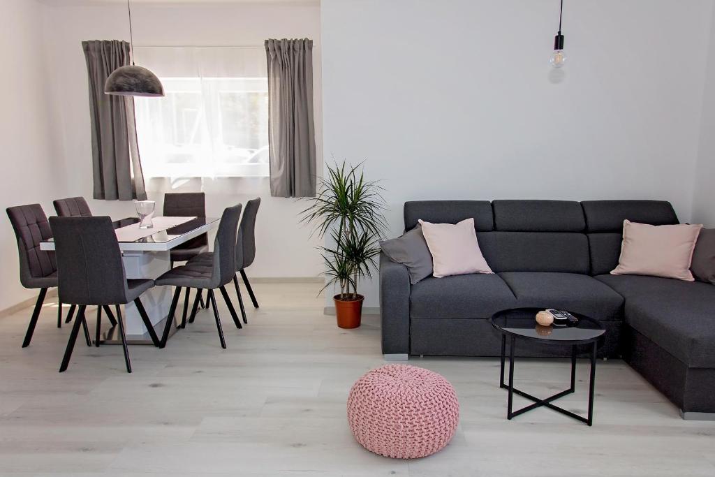 a living room with a couch and a table at Apartment Stocic in Rogoznica