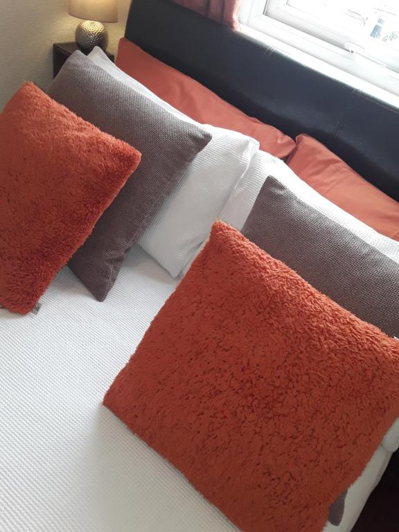 a bed with different colored pillows on it at 140 Bond in Blackpool