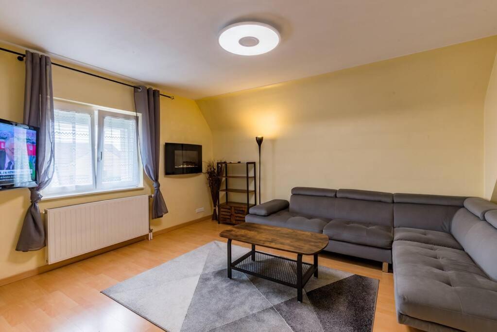 a living room with a couch and a table at séjour 6 pers.( atypique ) f4 110 m2 in Houssen