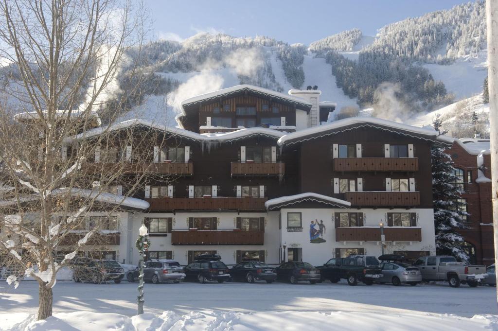 a large building with cars parked in the snow at Mountain Chalet Aspen in Aspen