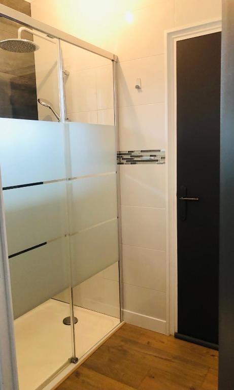 a glass shower in a room with a door at Maison la Londe in La Londe-les-Maures
