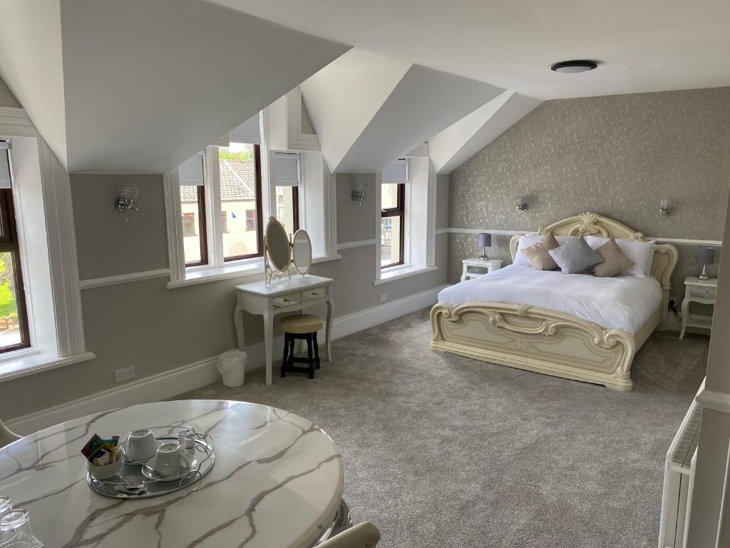 a large bedroom with a bed and a table at The Imperial Garvagh in Garvagh