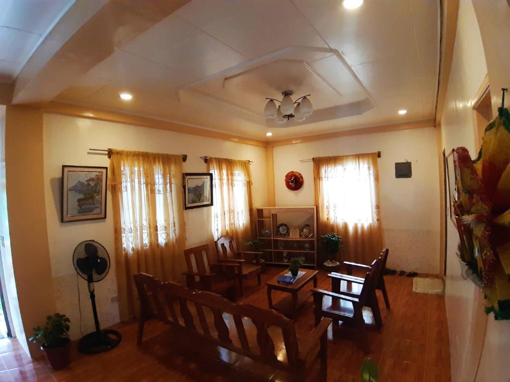 a living room with a dining room table and chairs at Horlina’s Homestay in Basco