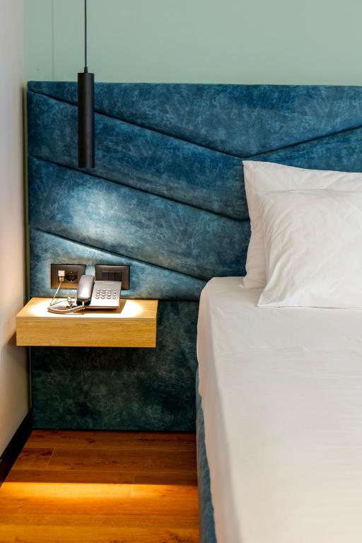 Postel nebo postele na pokoji v ubytování Seawave Hotel