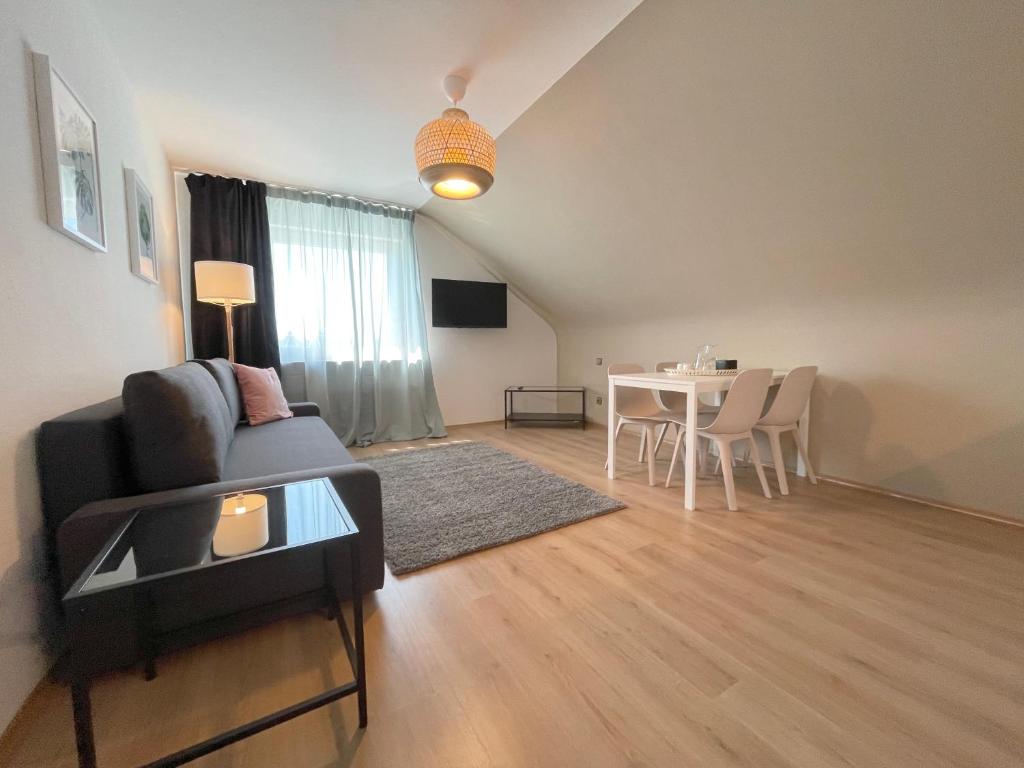 a living room with a couch and a table at Cityapartment SB Am Homburg in Saarbrücken