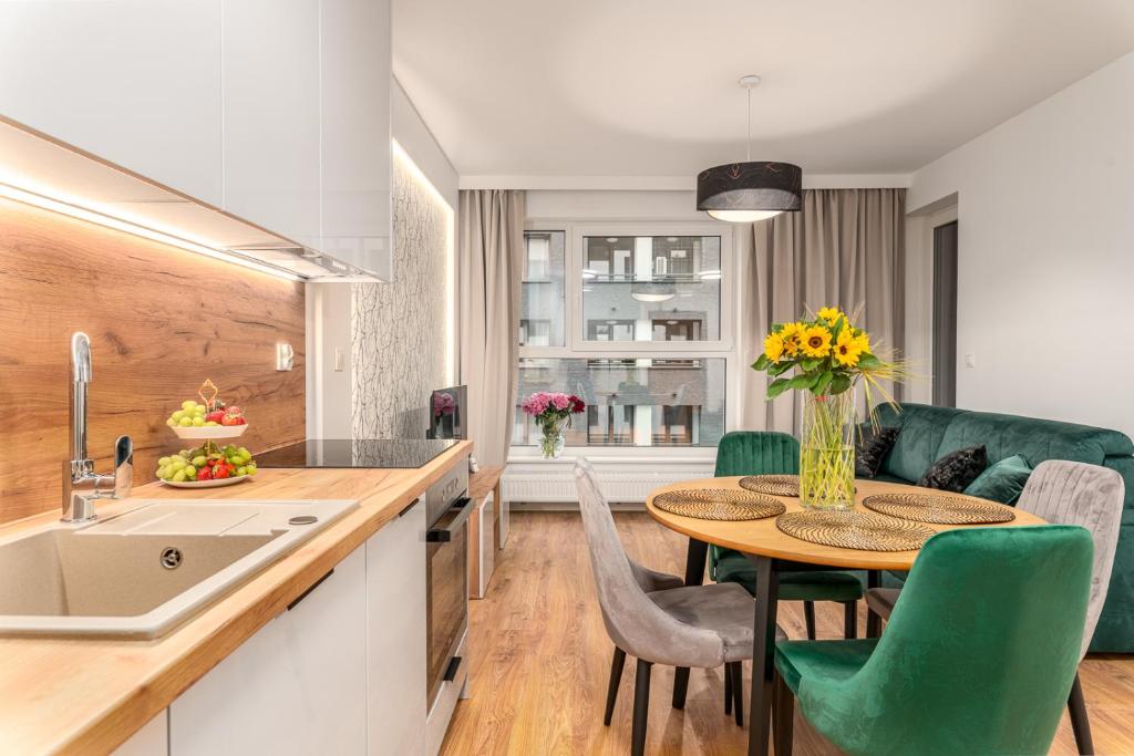 a kitchen and dining room with a table and chairs at Star4You II Apartments in Wrocław