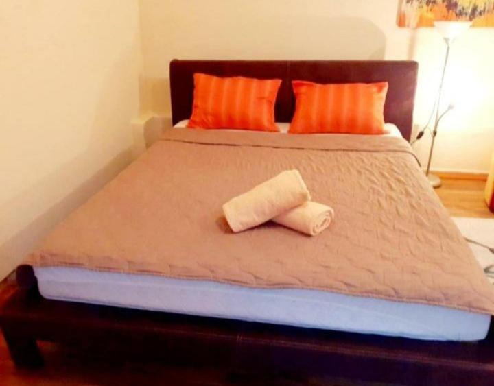 a bed with two rolled towels on top of it at Apartman Sarajevo in Sarajevo