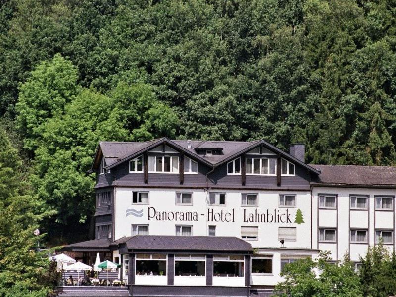 a large building with a sign for a hotel at Hotel Lahnblick in Bad Laasphe