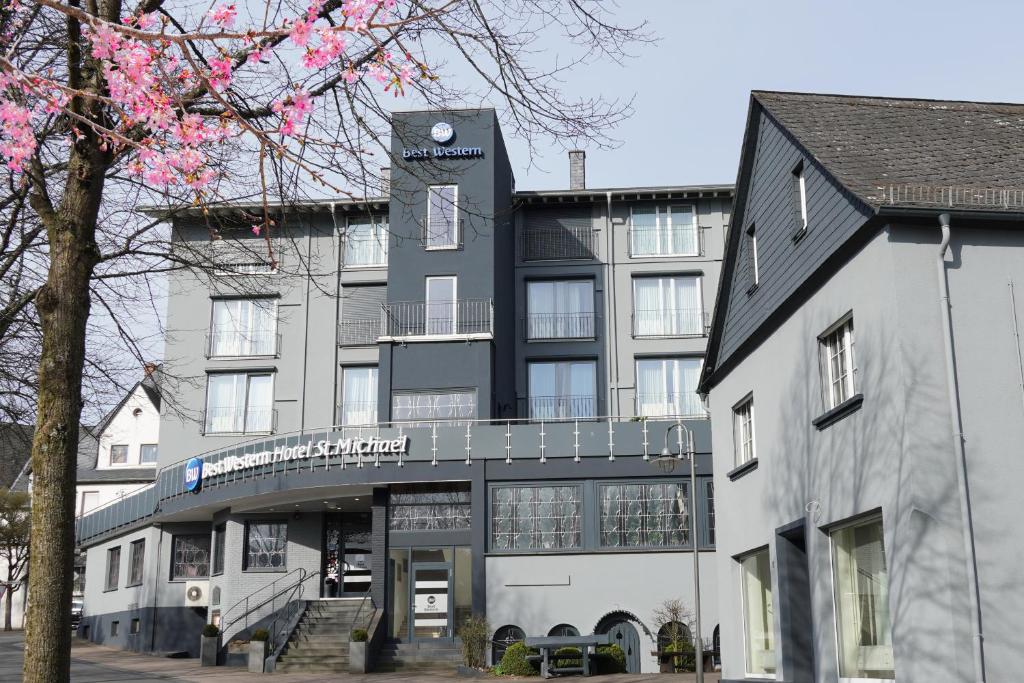 a building with a sign on the front of it at Best Western Hotel St. Michael in Morbach