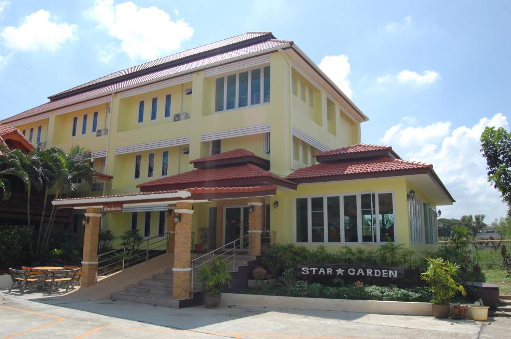 a yellow building with a sign in front of it at Saengthong Resort Chiangmai in Chiang Mai