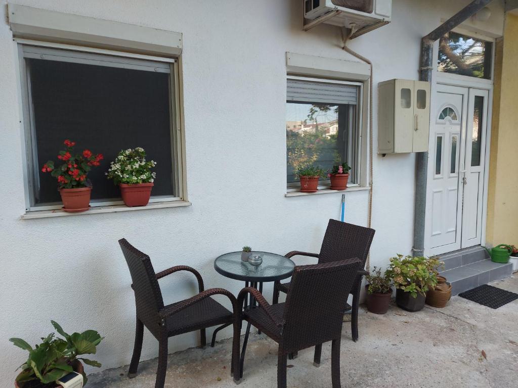 a patio with a table and chairs and a window at Eid in Mostar