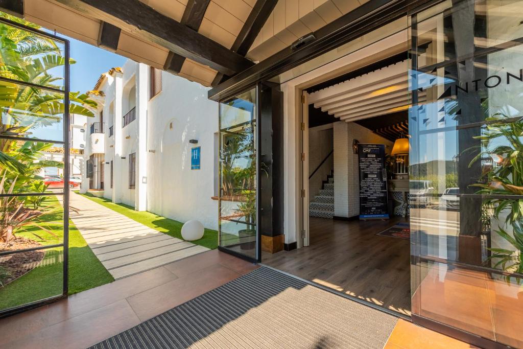 an open entrance to a building with glass doors at Hotel Antonio II in Zahara de los Atunes