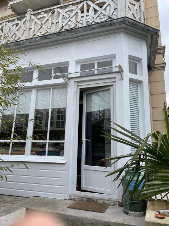 une porte d'entrée blanche d'une maison dans l'établissement La Fantaisie, à Villers-sur-Mer