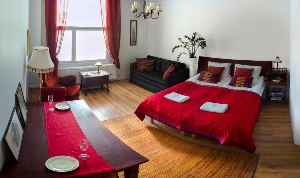 um quarto com uma cama grande e um cobertor vermelho em Salpalinjan Hovi em Lappeenranta