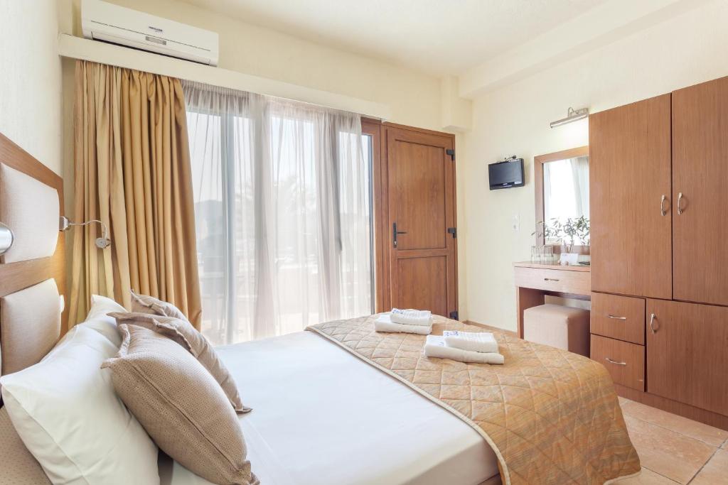 a hotel room with a bed and a window at Blue Green Bay in Panormos Skopelos