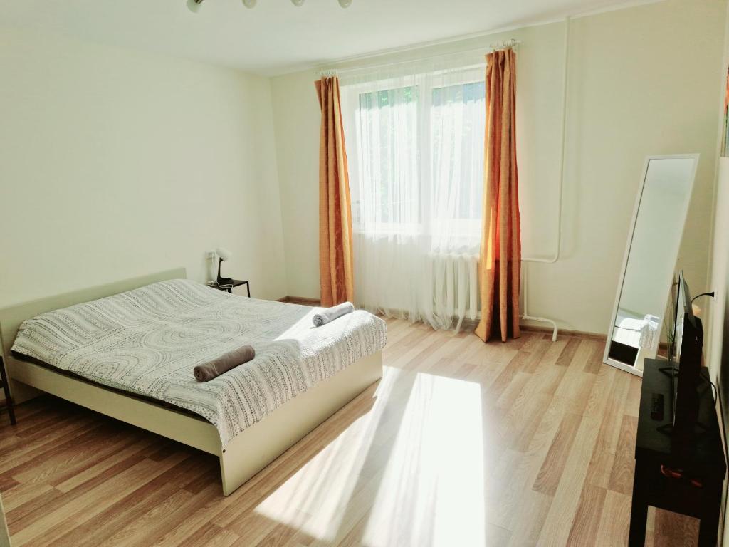 a bedroom with a bed and a large window at M&M Apartment X SELF CHECK-IN in Panevėžys