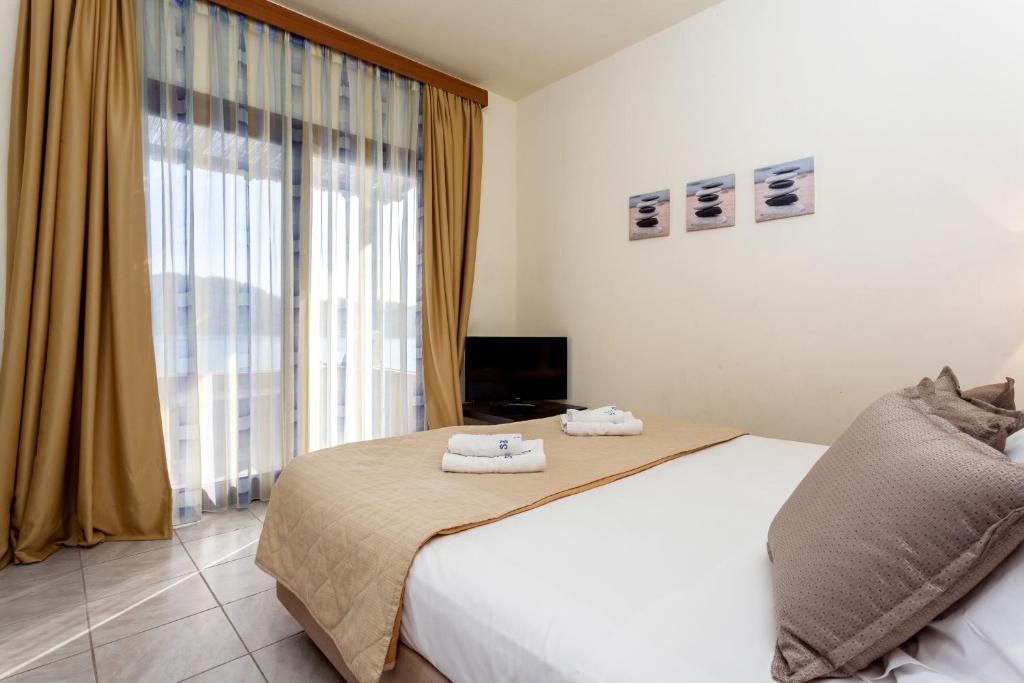 a bedroom with a bed and a large window at Blue Green Bay in Panormos Skopelos