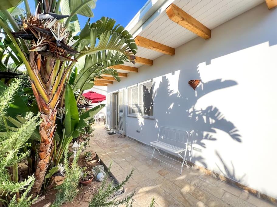 a patio with a bench on the side of a house at Casa Comada - Torre Lapillo in Torre Lapillo