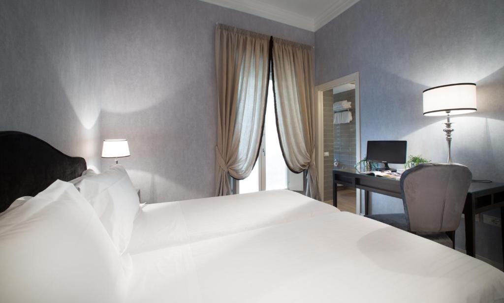 Łóżko lub łóżka w pokoju w obiekcie San Giuliano Inn