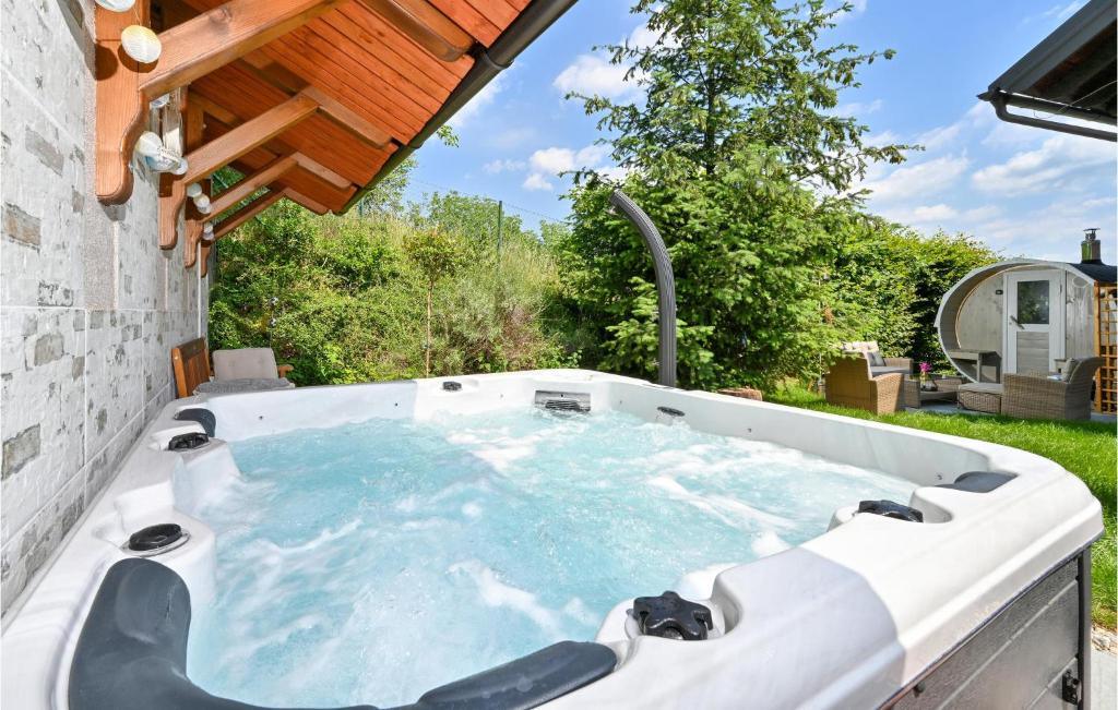 a jacuzzi tub in the backyard of a house at Cozy Home In Zagreb With Sauna in Zagreb