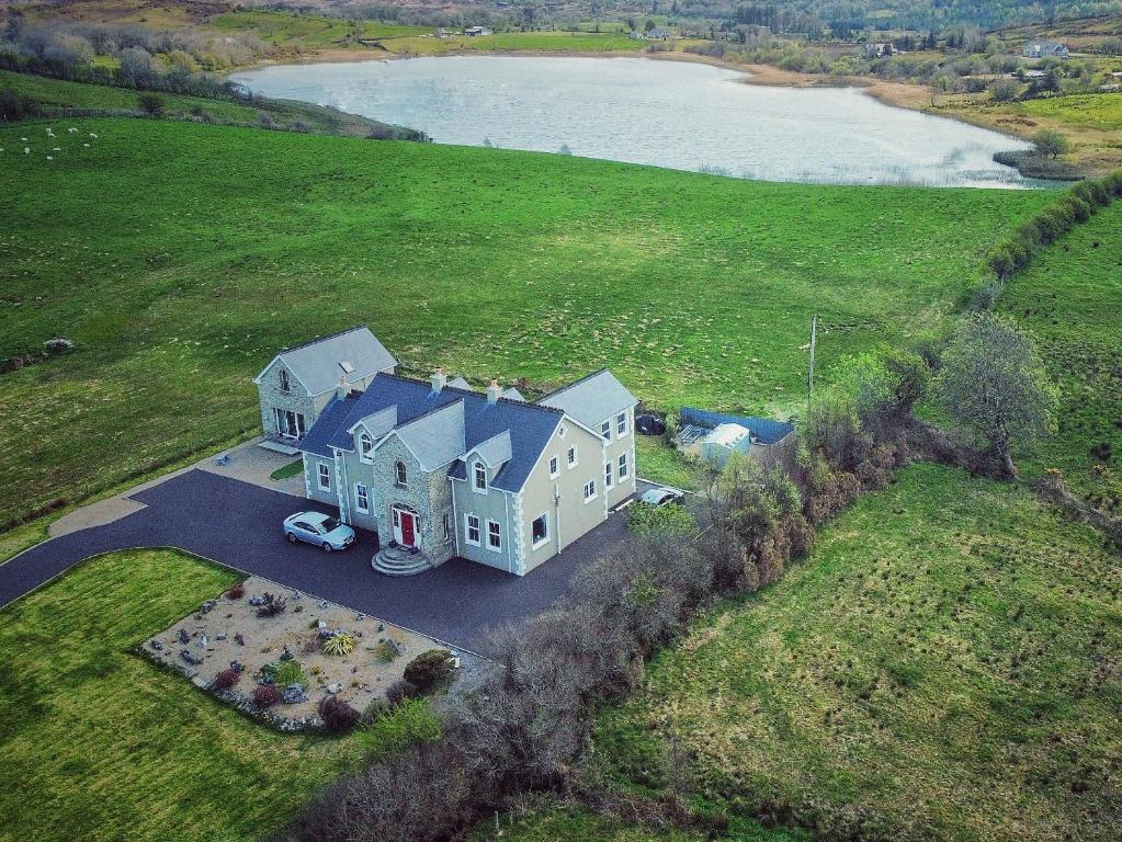 an aerial view of a large house with a car parked in front at Tully View House in Donegal