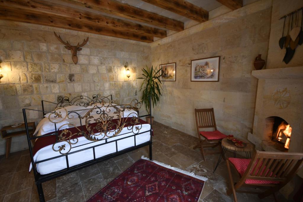 Postel nebo postele na pokoji v ubytování Lavinia Cappadocia Cave