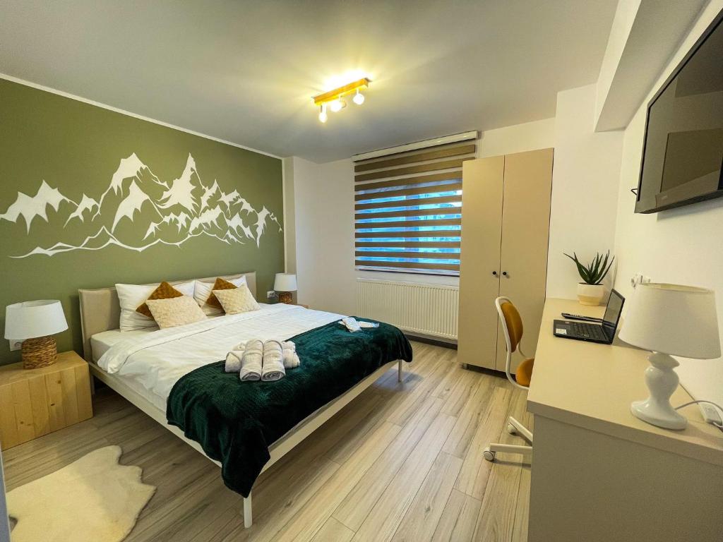 a bedroom with a bed with mountains painted on the wall at Tudor's Mountain Retreat in Campina