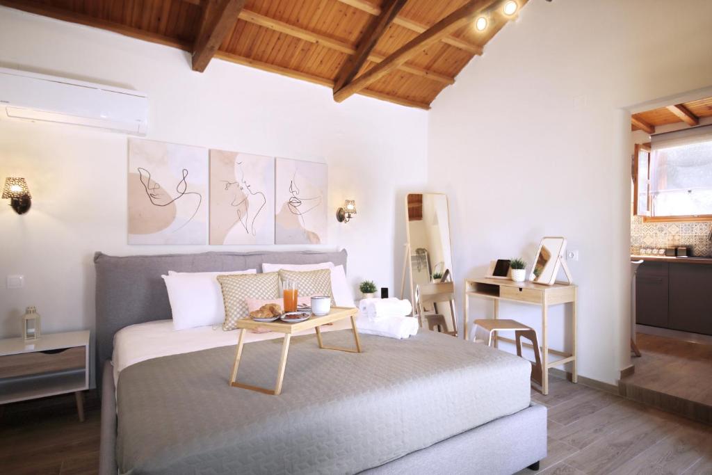 a bedroom with a bed with a table on it at Dafnes in Skopelos Town