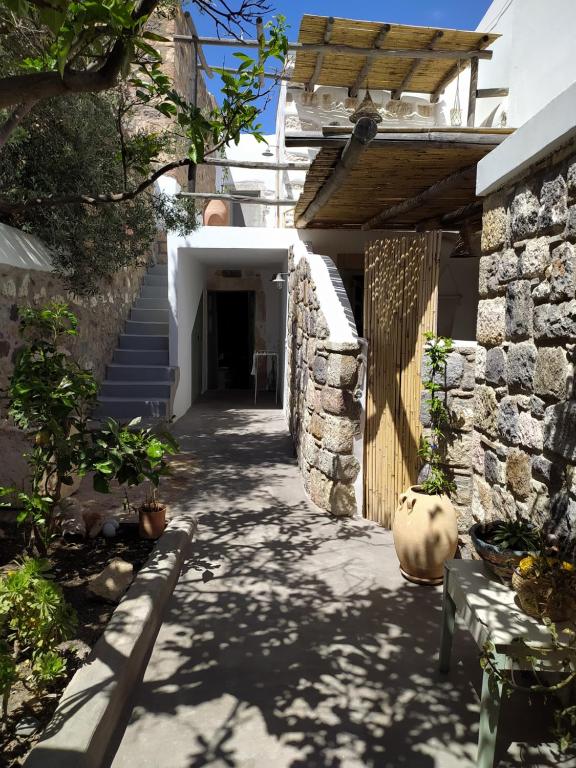 a hallway of a house with a stone wall at Latmos 1860 in Skala