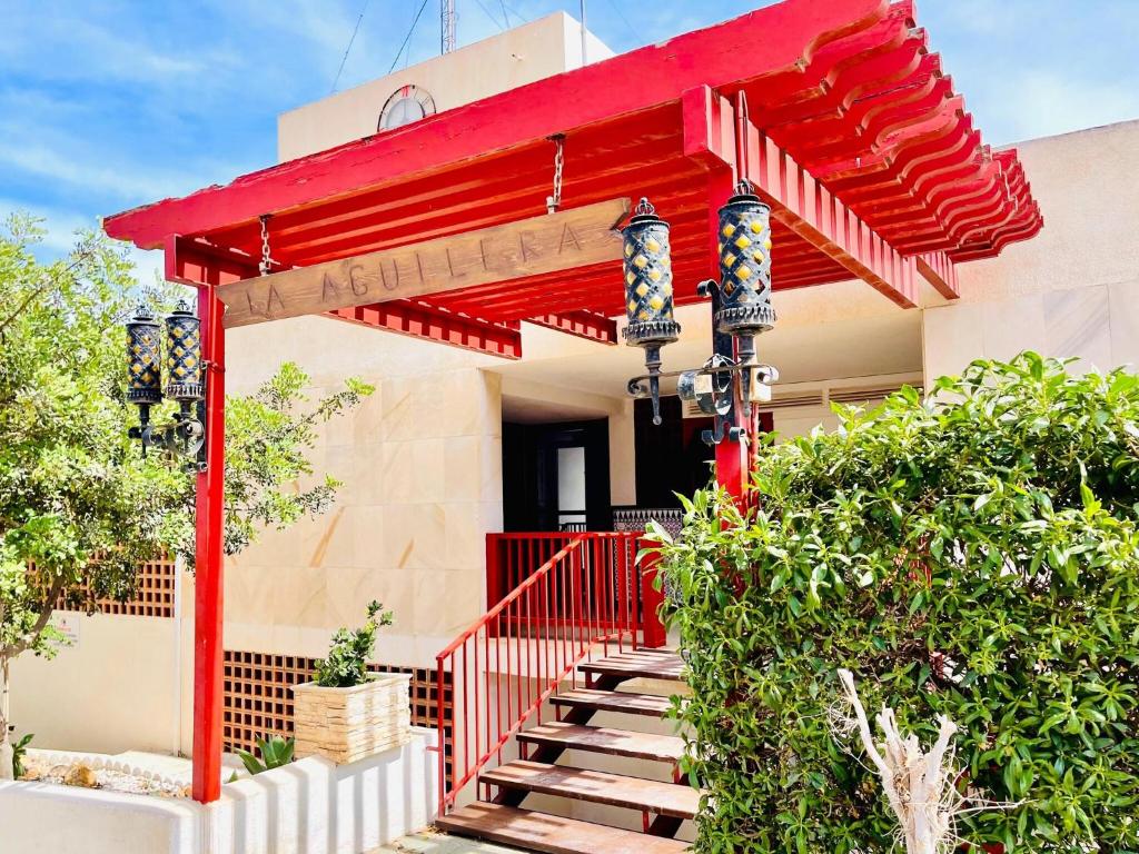 una entrada roja a una casa con techo rojo en Sea View Escape in La Garrofa, en La Garrofa