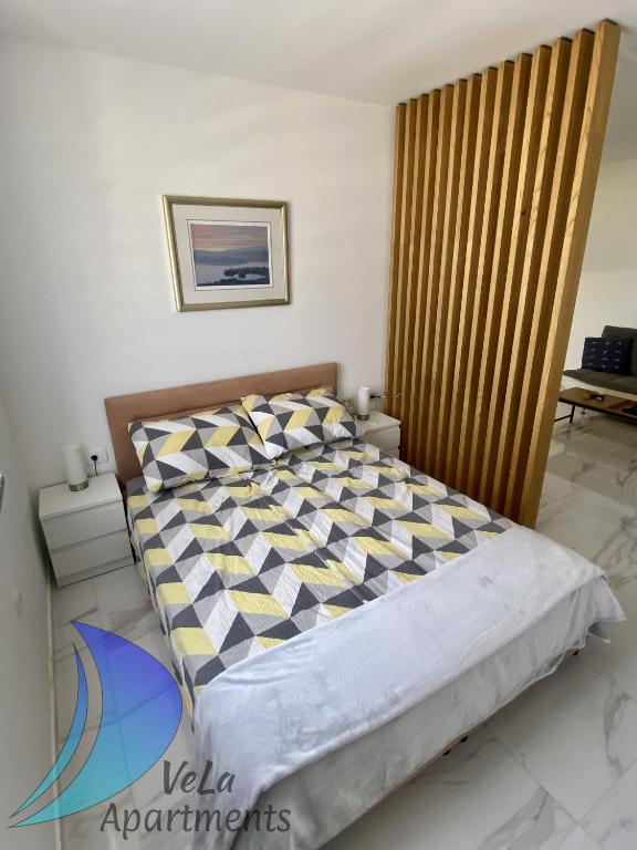 Posteľ alebo postele v izbe v ubytovaní VeLa Apartments