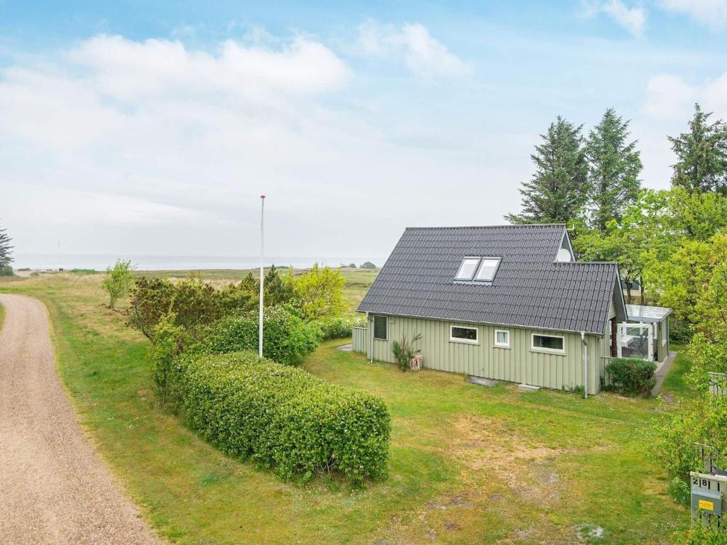 a house with a gravel road in front of it at 6 person holiday home in Hemmet in Hemmet