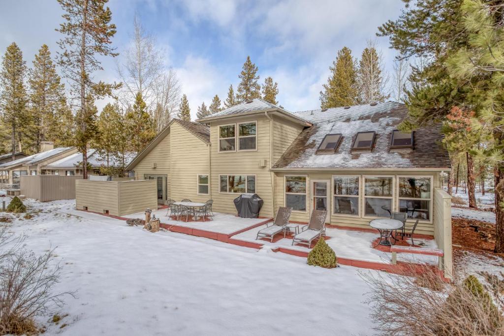 a house with a patio in the snow at Mugho 10 - Meredith Lodging in Sunriver