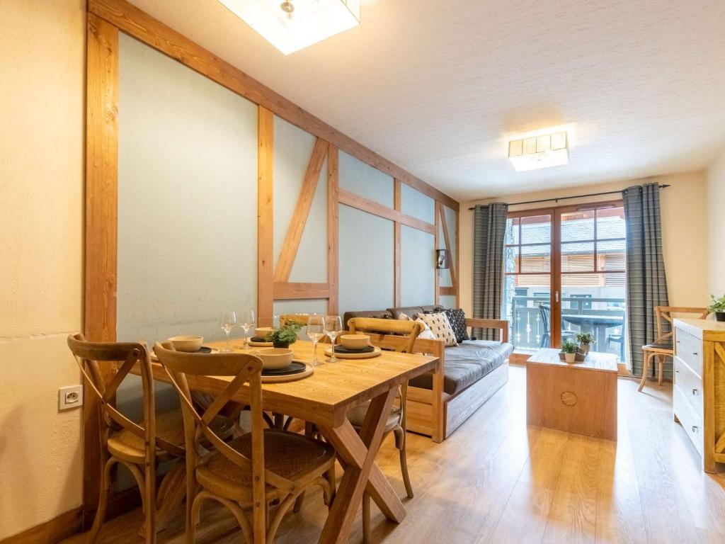 a dining room with a table and a couch at Appartement Saint-Lary-Soulan, 2 pièces, 6 personnes - FR-1-296-403 in Saint-Lary-Soulan