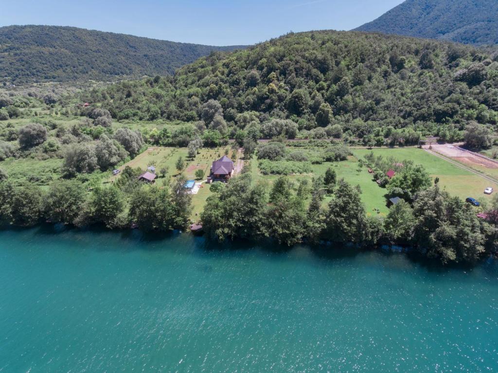 an aerial view of a house next to the water at Guest House VEZ Bihac in Bihać
