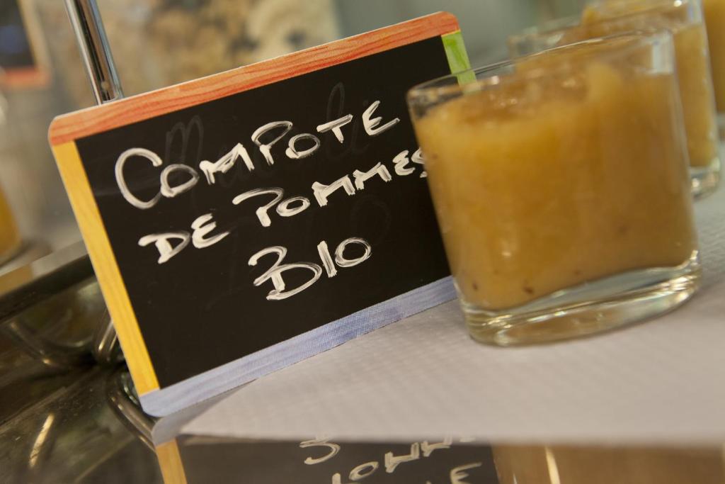 a sign on a counter with a drink on it at Logis Hôtel Duquesne in Nantes