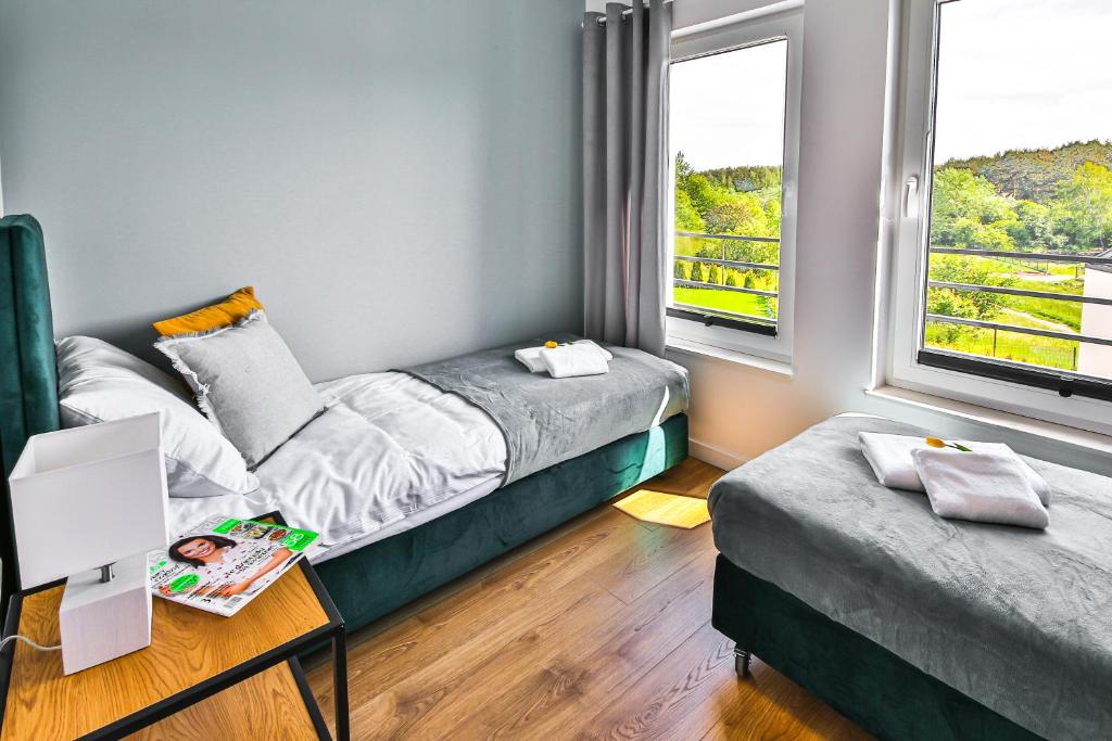 Postel nebo postele na pokoji v ubytování Klif Resort Apartamenty