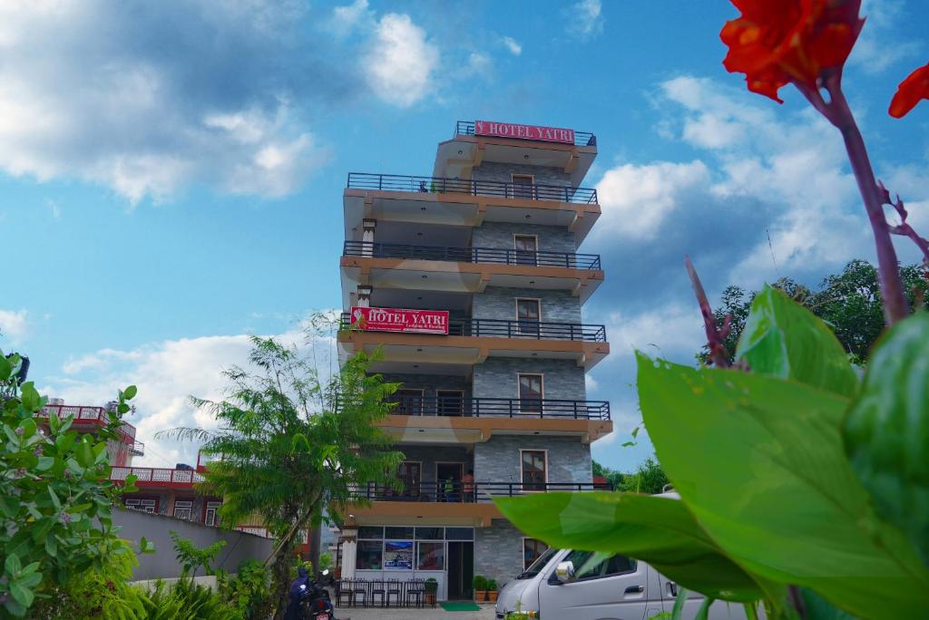a tall building with a red sign on it at Hotel Yatri in Pokhara