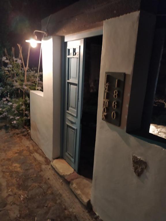 a door to a house with a sign on it at Latmos 1860 in Skala