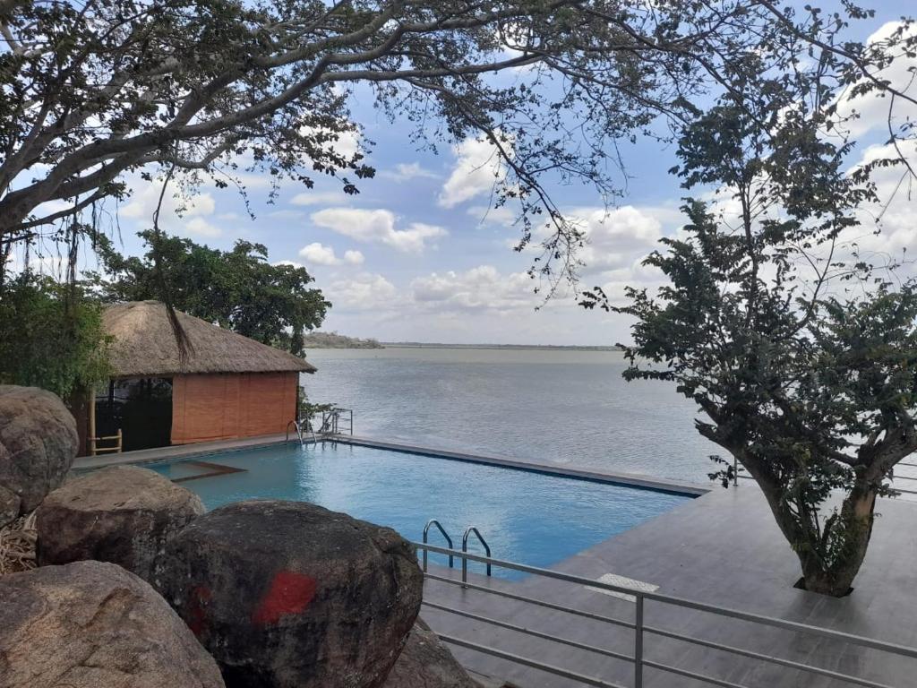a swimming pool with a view of the water at Oruwa Boutique Villas in Arugam Bay