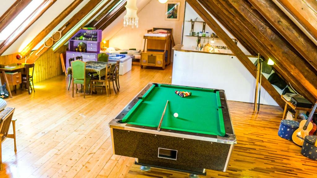 a room with a pool table in a attic at River loft in Ilirska Bistrica