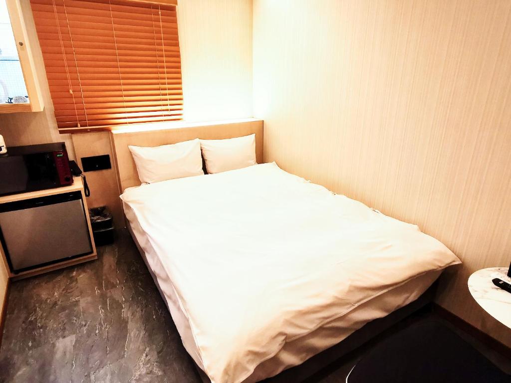 Postel nebo postele na pokoji v ubytování Hotel mond omiya
