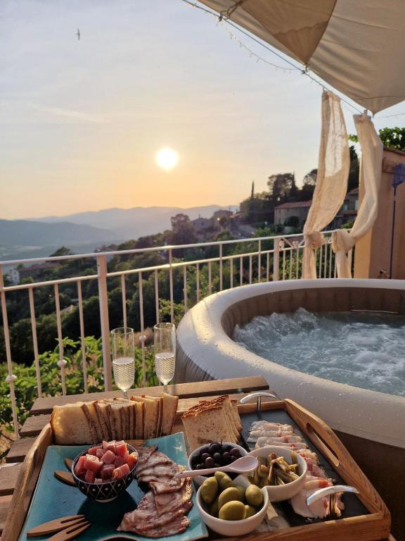 a tray of food on a table next to a hot tub at VETULONIA ROMANTICA in Vetulonia