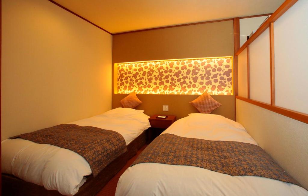 Postel nebo postele na pokoji v ubytování Itsuura Kanko Hotel