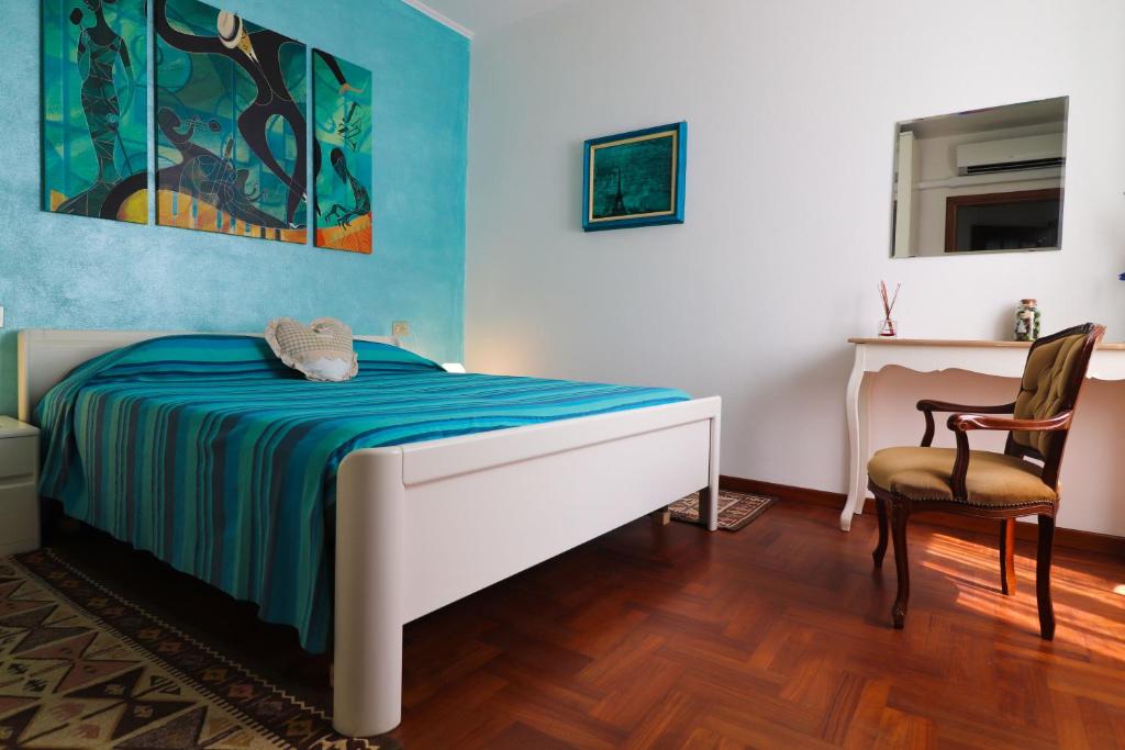 a bedroom with a bed and a desk and a chair at Da Stea guest house in Coreglia Ligure