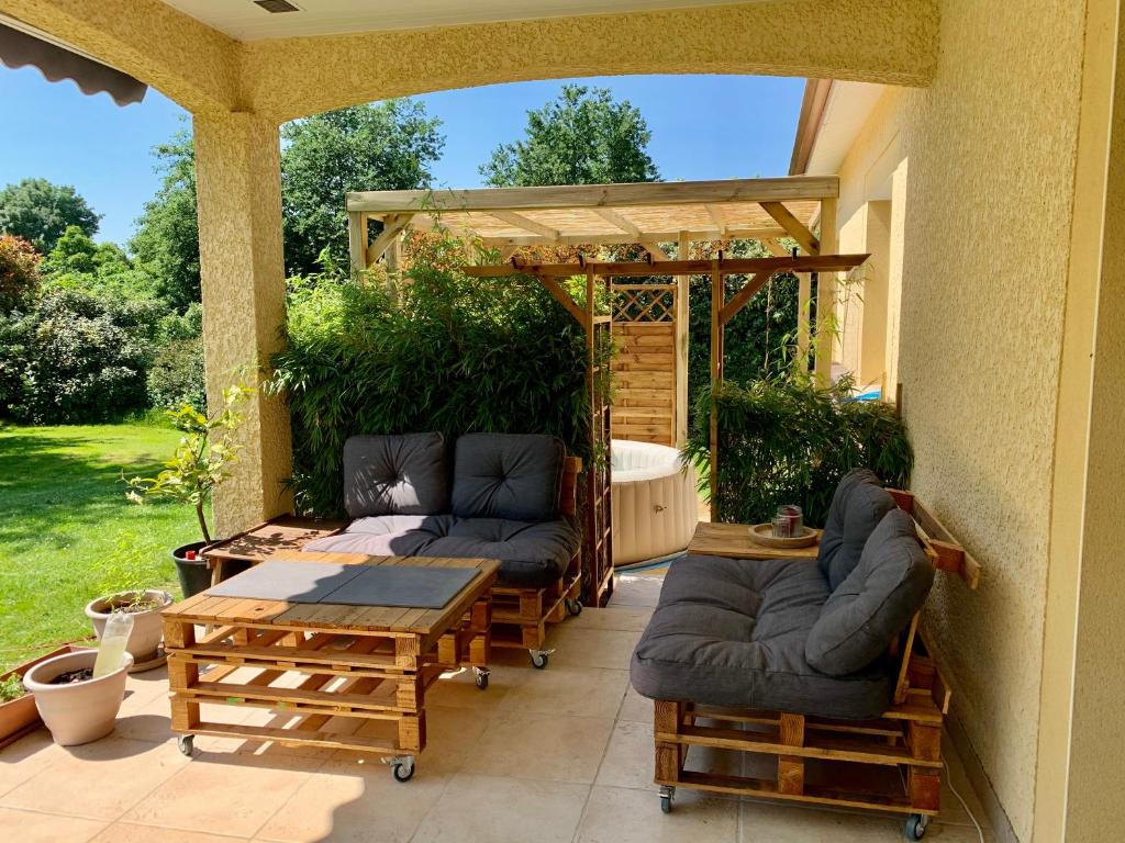 a patio with couches and a gazebo at Magnifique villa in Dieupentale