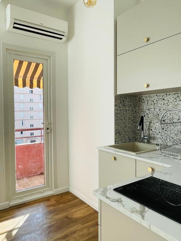 a kitchen with a sink and a window at Appartement Bonaparte centre ville d&#39;Ajaccio in Ajaccio